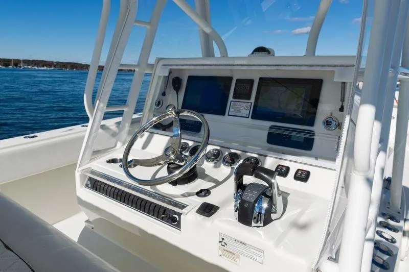 Slide: The Image of 2016 SeaVee 390Z boat console with steering wheel and navigation screens. - 27