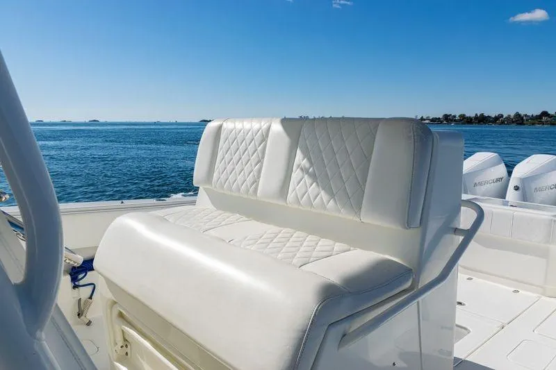 Slide: The Image of 2016 SeaVee 390Z boat with white cushioned seating, ocean view, and Mercury engines. - 31