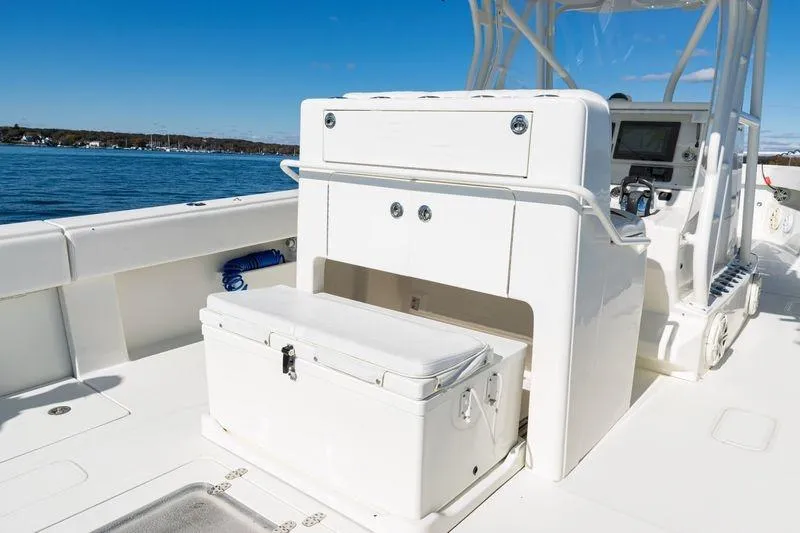 Slide: The Image of 2016 SeaVee 390Z boat interior with storage and seating, on a sunny day. - 34