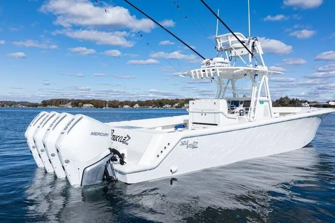 Slide: The Image of 2016 SeaVee 390Z boat on calm water under clear blue sky. - 4