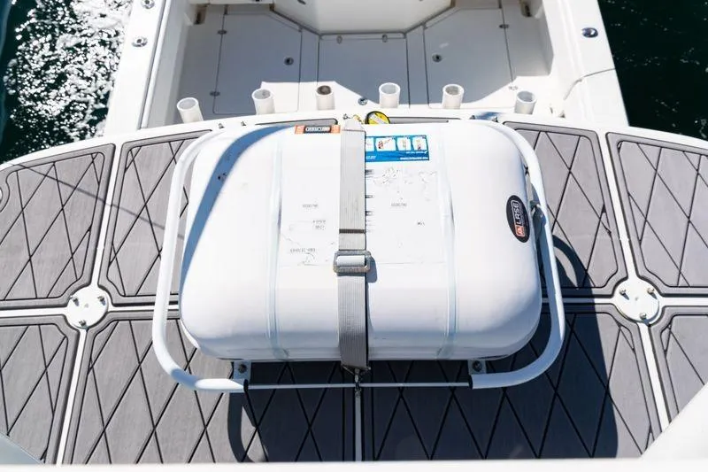 Slide: The Image of 2016 SeaVee 390Z boat deck with secured life raft, ocean in background. - 52