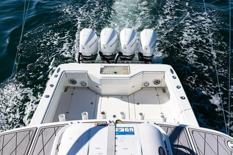 Slide: The Image of 2016 SeaVee 390Z boat with four outboard engines cruising on open water. - 53