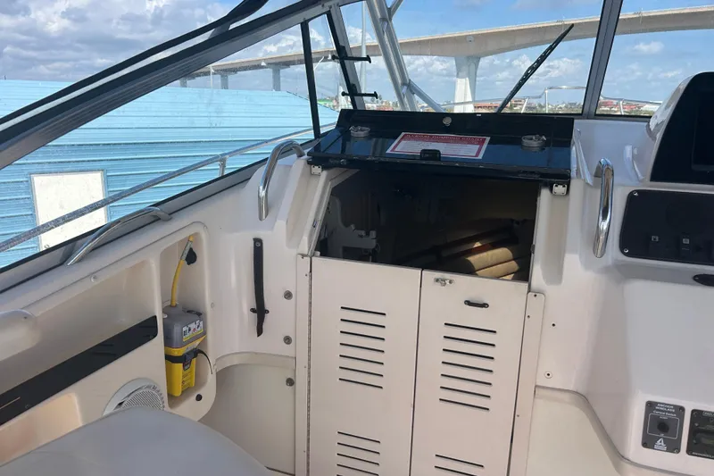 Slide: The Image of 2004 Grady-White Marlin 300 boat interior with storage compartment and control panel. - 12