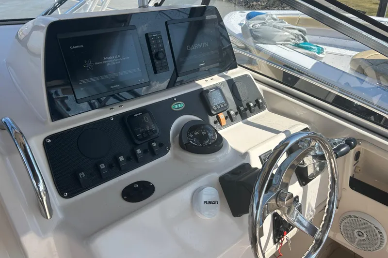 Slide: The Image of Control panel of a 2004 Grady-White Marlin 300 boat with Garmin displays. - 18