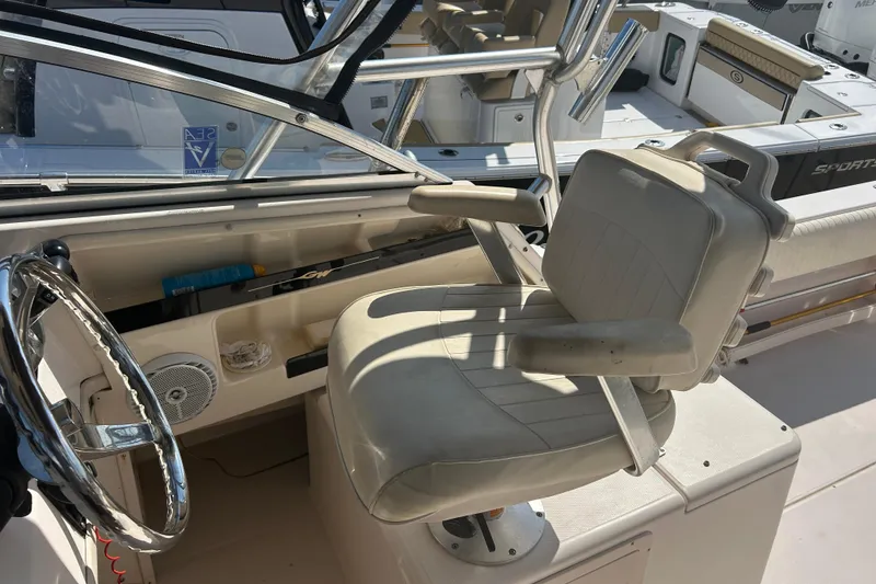 Slide: The Image of 2004 Grady-White Marlin 300 helm with steering wheel and captain's chair. - 19