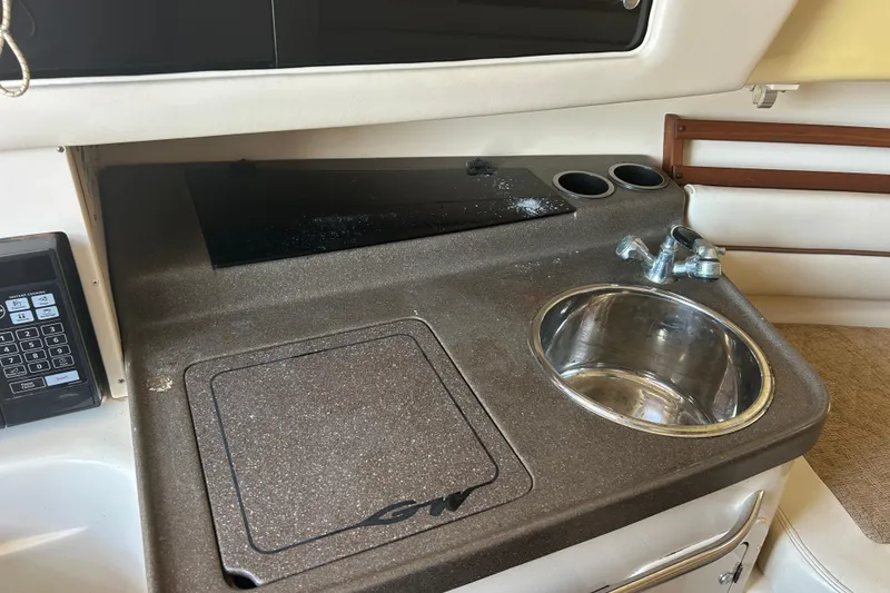 Slide: The Image of 2004 Grady-White Marlin 300 boat interior with sink and control panel. - 20