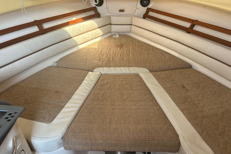 Slide: The Image of 2004 Grady-White Marlin 300 cabin interior with cushioned seating and wood accents. - 21