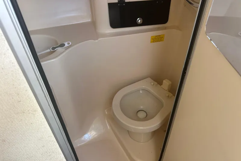 Slide: The Image of 2004 Grady-White Marlin 300 boat bathroom interior with toilet. - 22