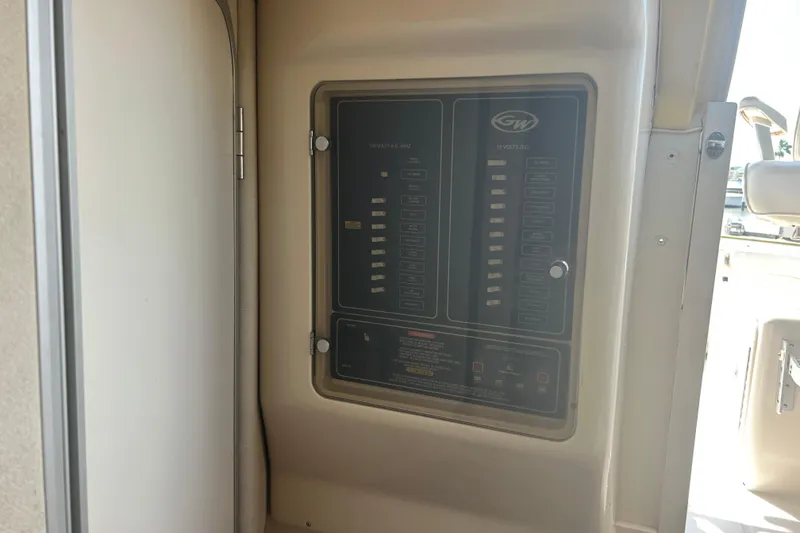 Slide: The Image of Electrical panel on a 2004 Grady-White Marlin 300 boat, featuring various switches. - 24