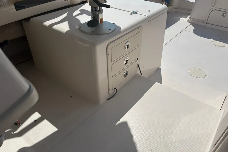 Slide: The Image of 2004 Grady-White Marlin 300 boat interior with storage drawers and seating area. - 28