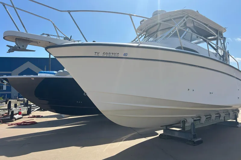 Slide: The Image of 2004 Grady-White Marlin 300 boat on trailer under clear sky. - 3