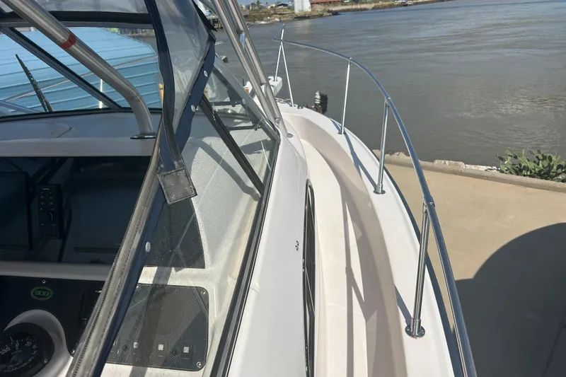 Slide: The Image of 2004 Grady-White Marlin 300 boat docked by the water, showcasing deck and railing. - 31