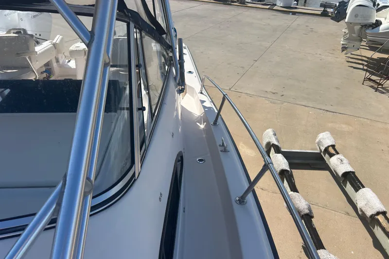 Slide: The Image of 2004 Grady-White Marlin 300 boat on trailer, dockside view. - 32