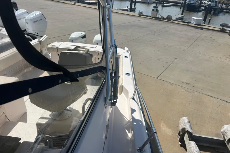 Slide: The Image of 2004 Grady-White Marlin 300 boat docked, featuring Mercury engines and spacious deck. - 37