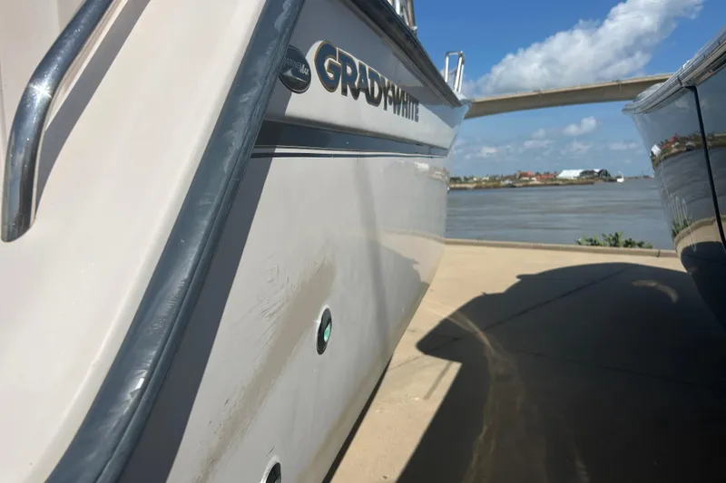 Slide: The Image of 2004 Grady-White Marlin 300 boat docked by a scenic waterfront. - 39