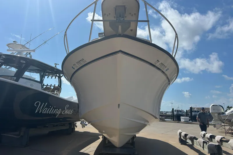 Slide: The Image of 2004 Grady-White Marlin 300 boat docked under a clear blue sky. - 4