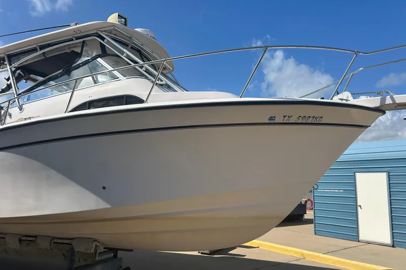 Slide: The Image of 2004 Grady-White Marlin 300 boat on trailer, clear sky background. - 41