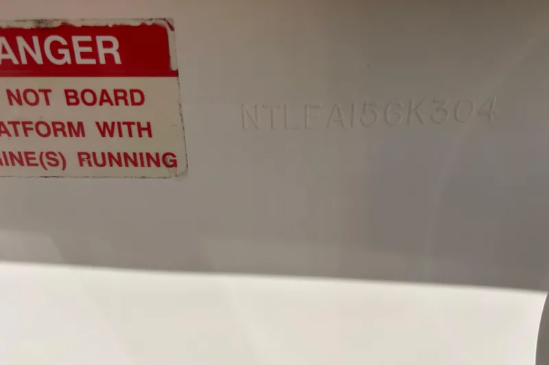 Slide: The Image of Warning label on 2004 Grady-White Marlin 300 boat, advising caution with engines running. - 42