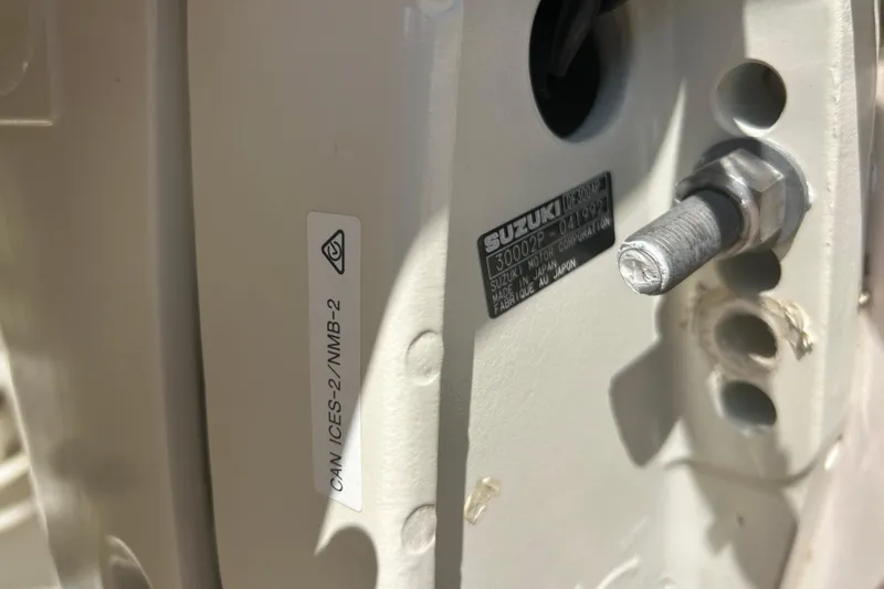 Slide: The Image of Close-up of a 2004 Grady-White Marlin 300 boat component with Suzuki label. - 43