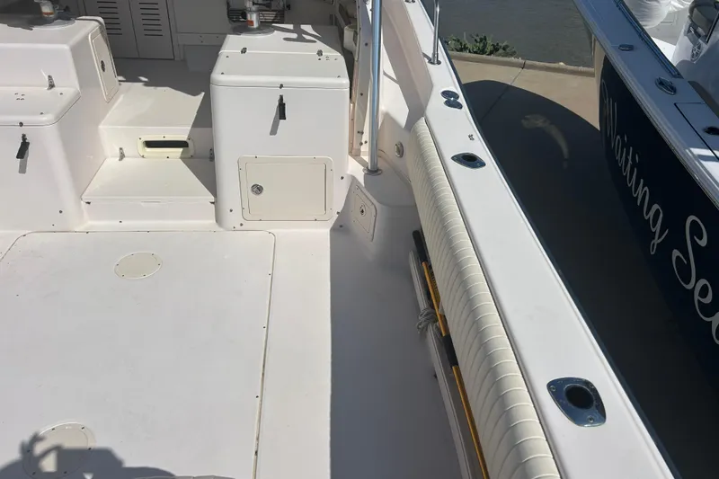 Slide: The Image of 2004 Grady-White Marlin 300 boat deck with storage compartments and seating. - 5