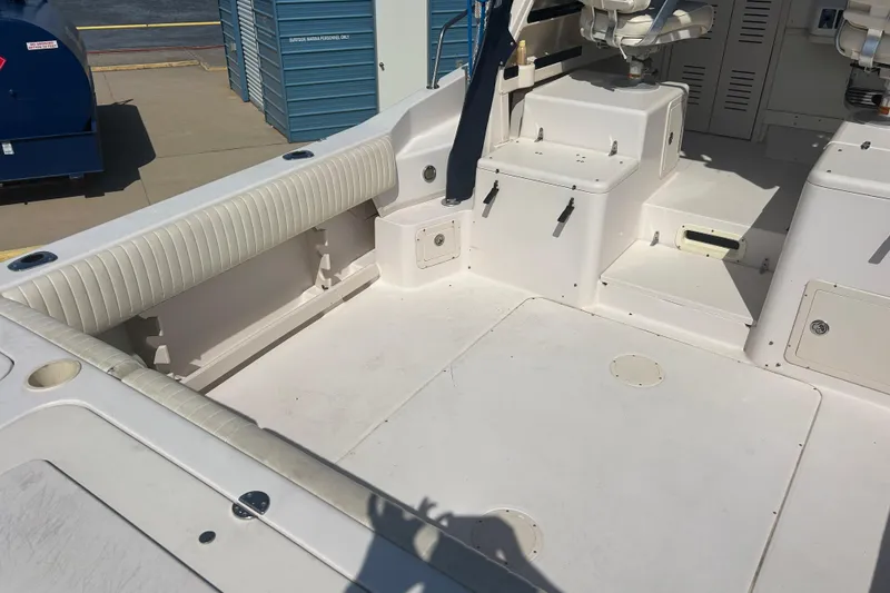 Slide: The Image of 2004 Grady-White Marlin 300 boat interior with seating and storage compartments. - 6