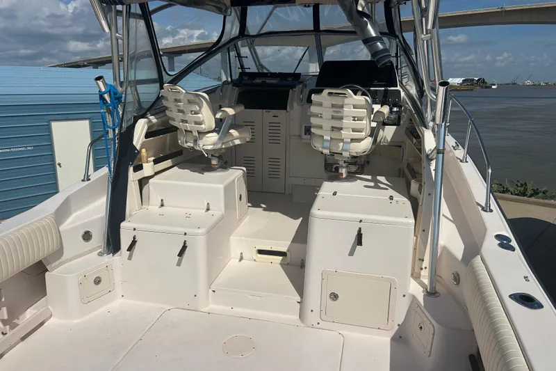 Slide: The Image of 2004 Grady-White Marlin 300 boat interior with dual captain chairs and control panel. - 7