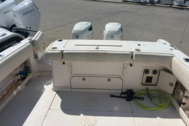 Slide: The Image of 2004 Grady-White Marlin 300 boat deck with dual outboard engines and storage compartments. - 9