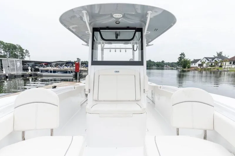 Slide: The Image of Manufacturer Provided Image: 2025 Sea Hunt Gamefish 30 Forward Seating boat at a marina dock. - 7