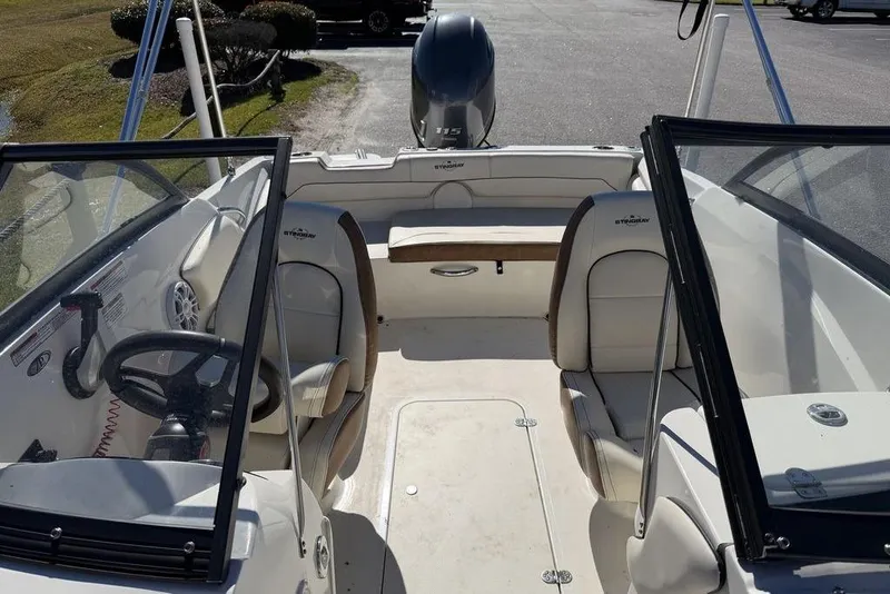 Slide: The Image of 2024 Stingray 191 DC boat displayed outdoors on a sunny day. - 12