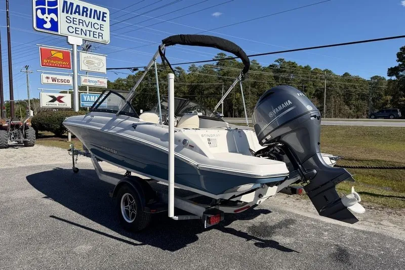 Slide: The Image of 2024 Stingray 191 DC boat with Yamaha engine at marine service center. - 2