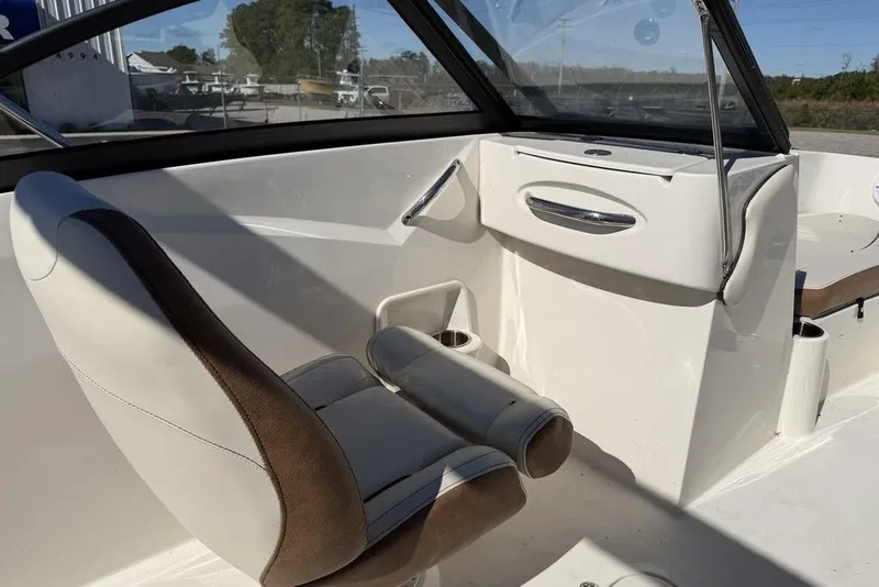 Slide: The Image of 2024 Stingray 191 DC boat with Yamaha outboard motor, parked outdoors. - 6