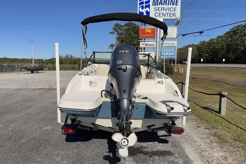 Slide: The Image of 2024 Stingray 191 DC boat interior with steering wheel and seating. - 8