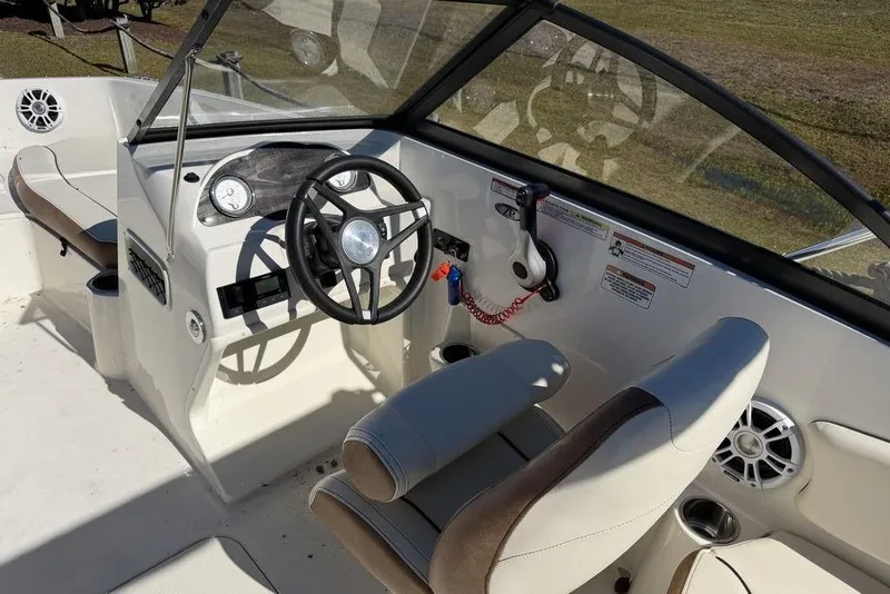 Slide: The Image of 2024 Stingray 191 DC boat dashboard with steering wheel and controls. - 9