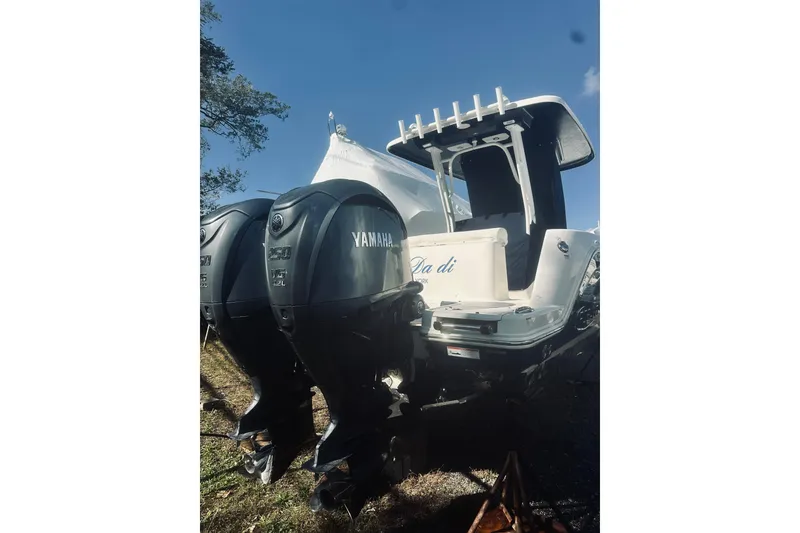 Slide: The Image of 2022 Robalo R272 Center Console boat with dual Yamaha outboard engines. - 11