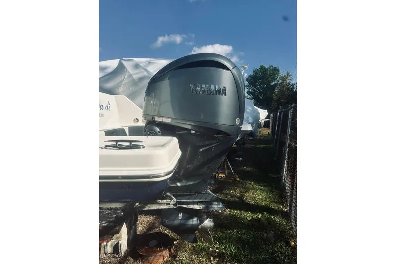 Slide: The Image of 2022 Robalo R272 Center Console with Yamaha outboard engine, parked outdoors. - 12