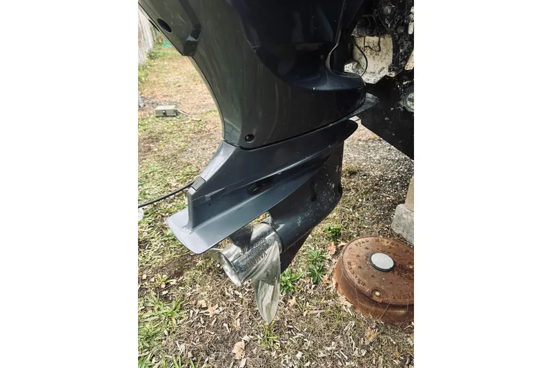 Slide: The Image of 2022 Robalo R272 Center Console boat engine propeller on grass. - 14