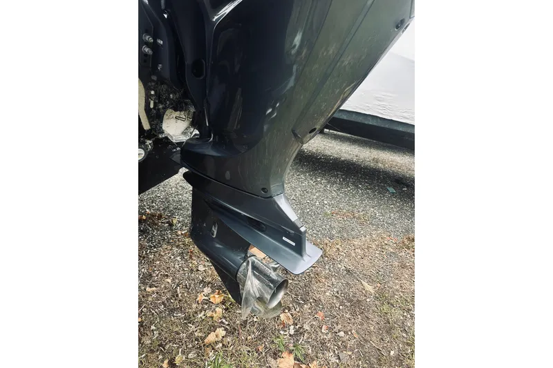 Slide: The Image of 2022 Robalo R272 Center Console boat engine close-up on gravel. - 19