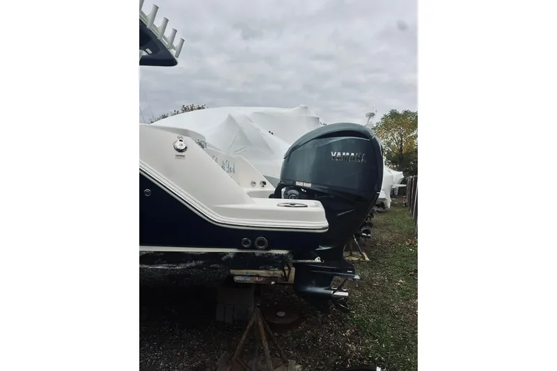 Slide: The Image of 2022 Robalo R272 Center Console boat with Yamaha outboard engine, parked outdoors. - 24