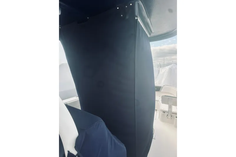 Slide: The Image of 2022 Robalo R272 Center Console interior with protective cover, showcasing seating and console area. - 30