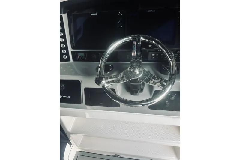 Slide: The Image of 2022 Robalo R272 Center Console steering wheel and dashboard controls. - 47