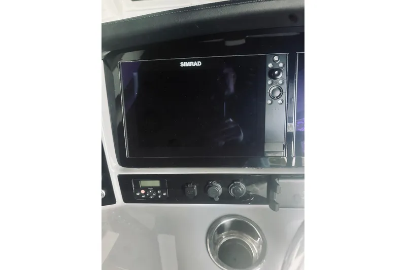 Slide: The Image of 2022 Robalo R272 Center Console dashboard with Simrad display and controls. - 49