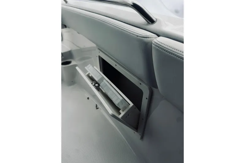 Slide: The Image of 2022 Robalo R272 Center Console boat storage compartment with open lid. - 69