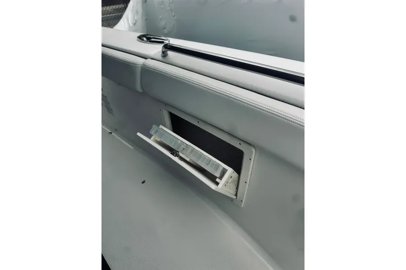 Slide: The Image of 2022 Robalo R272 Center Console boat interior with open storage compartment. - 72