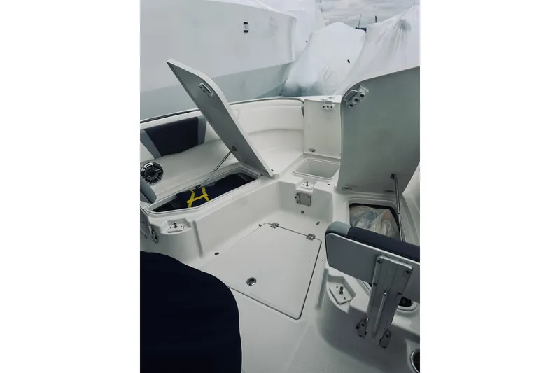 Slide: The Image of 2022 Robalo R272 Center Console boat interior with open storage compartments. - 76