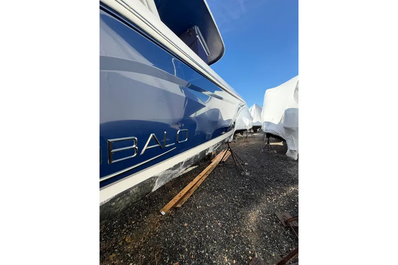 Slide: The Image of 2022 Robalo R272 Center Console boat in storage, blue hull, outdoor setting. - 8