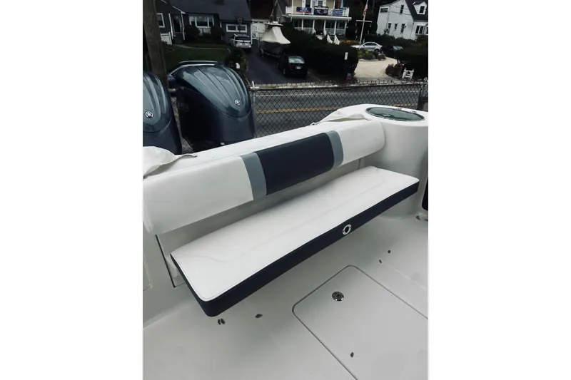 Slide: The Image of 2022 Robalo R272 Center Console boat seating area with dual engines in background. - 83