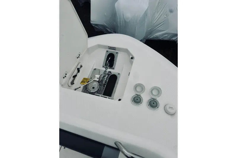 Slide: The Image of 2022 Robalo R272 Center Console boat anchor compartment and controls. - 84