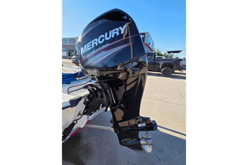 Slide: The Image of 2018 Mako Pro Skiff 17 CC with Mercury FourStroke outboard motor in a parking lot. - 4