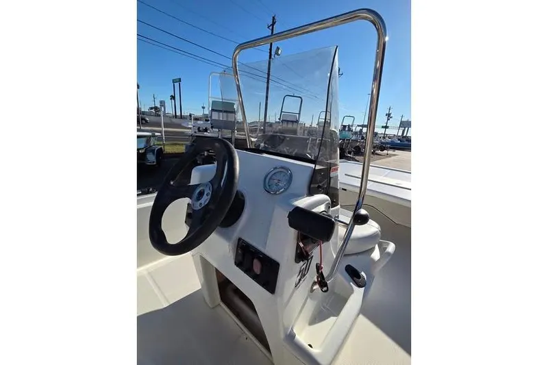 Slide: The Image of 2018 Mako Pro Skiff 17 CC boat console with steering wheel and controls. - 6