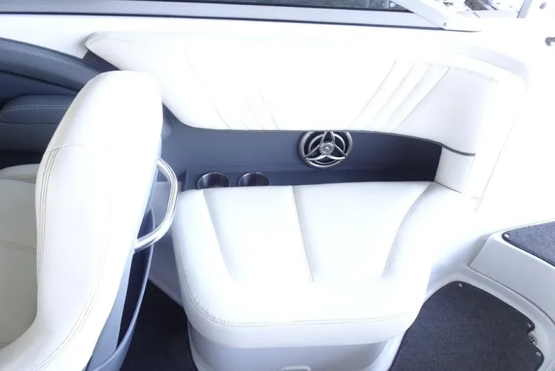 Slide: The Image of 2008 Cobalt 232 boat interior with white seating and built-in speaker. - 11